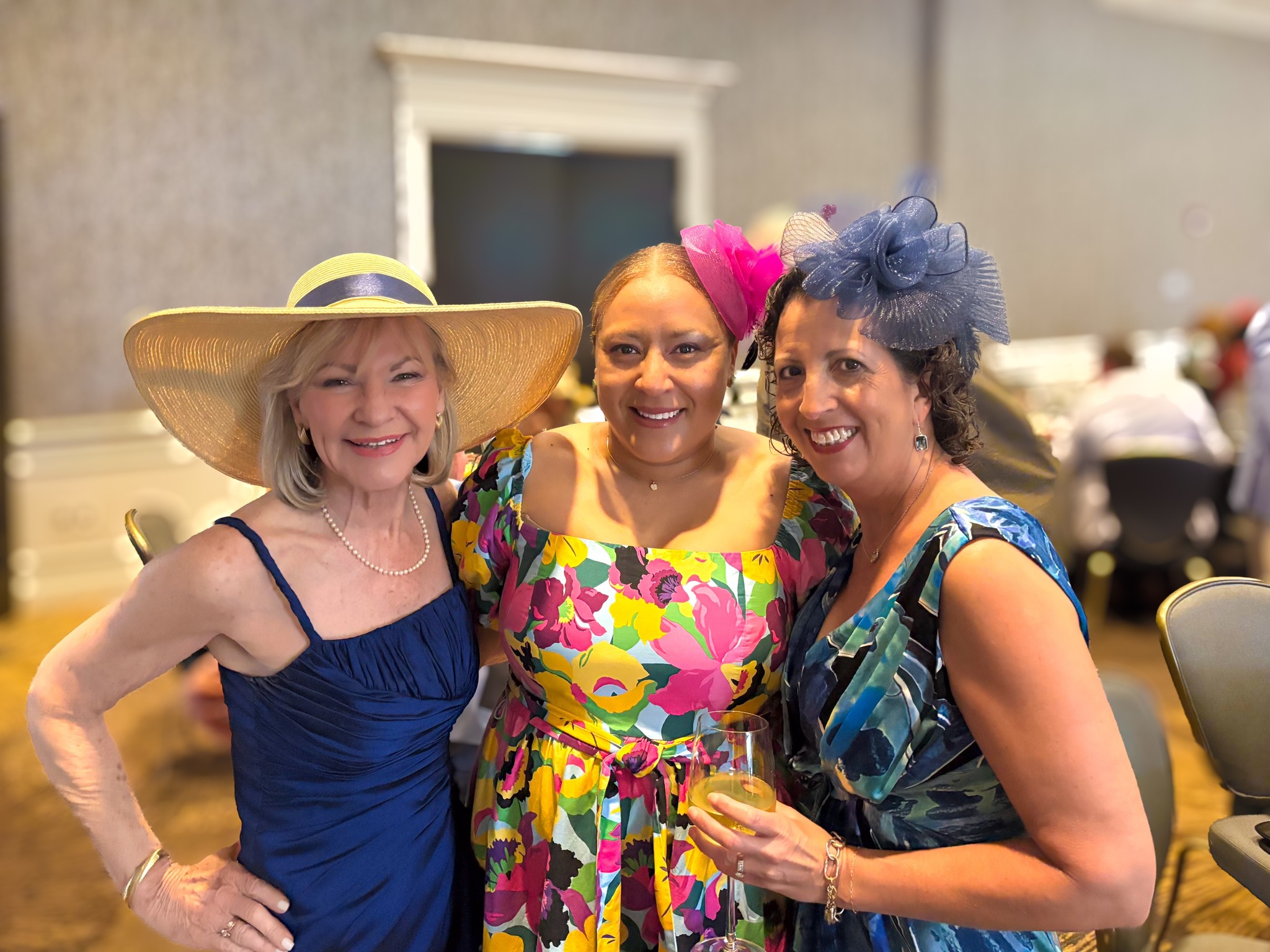 Three women with Derby Day hats