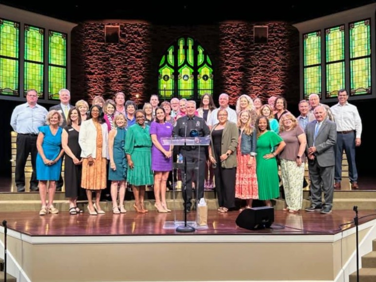 Leadership Collierville alumni on stage at a Collierville Chamber of Commerce member lunch.